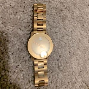 Movado rose gold watch with diamond in the face.